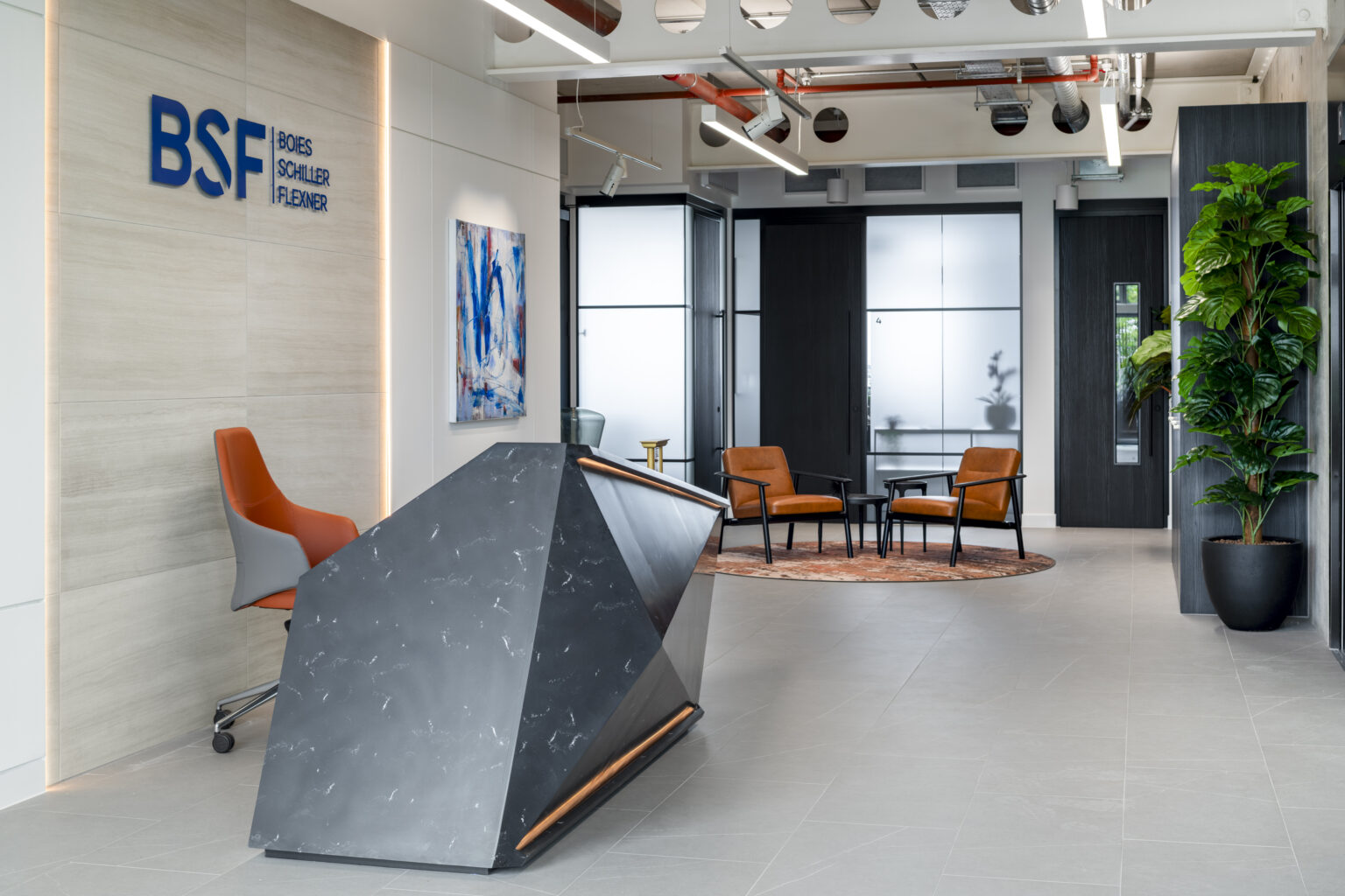 Commercial office reception featuring a bespoke dark solid surface reception desk Commercial office reception featuring a bespoke dark solid surface reception desk